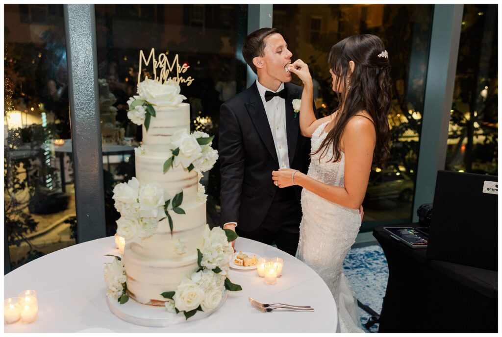 The Ray Hotel Wedding bride and groom feed each other cake