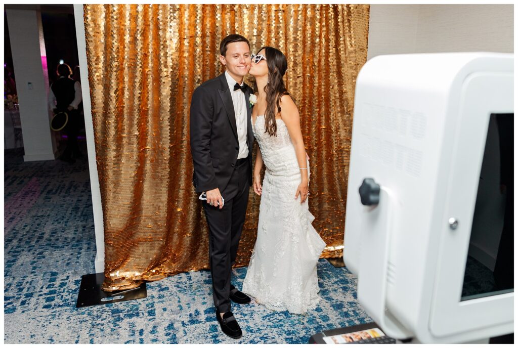 The Ray Hotel Wedding bride and groom kiss at the photo booth