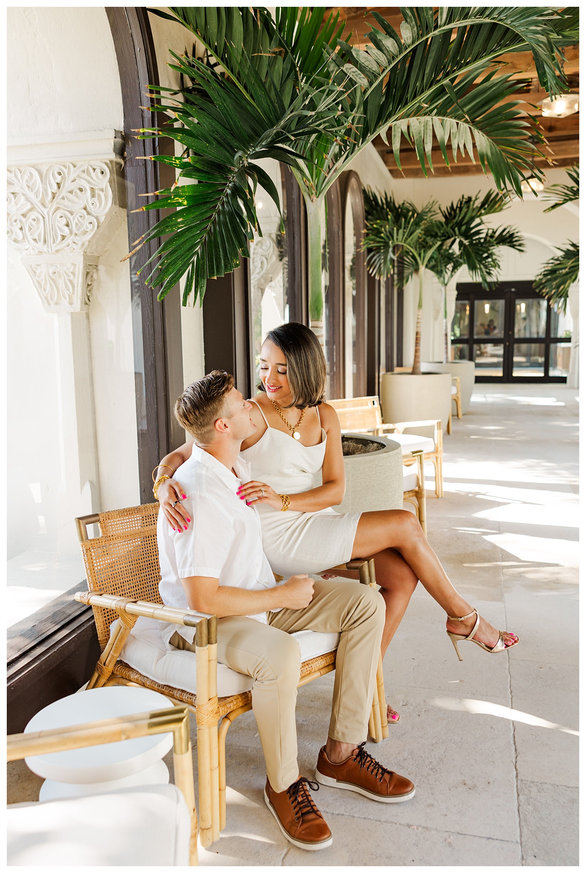 A couple poses for their engagement photos at The Boca Raton resort 