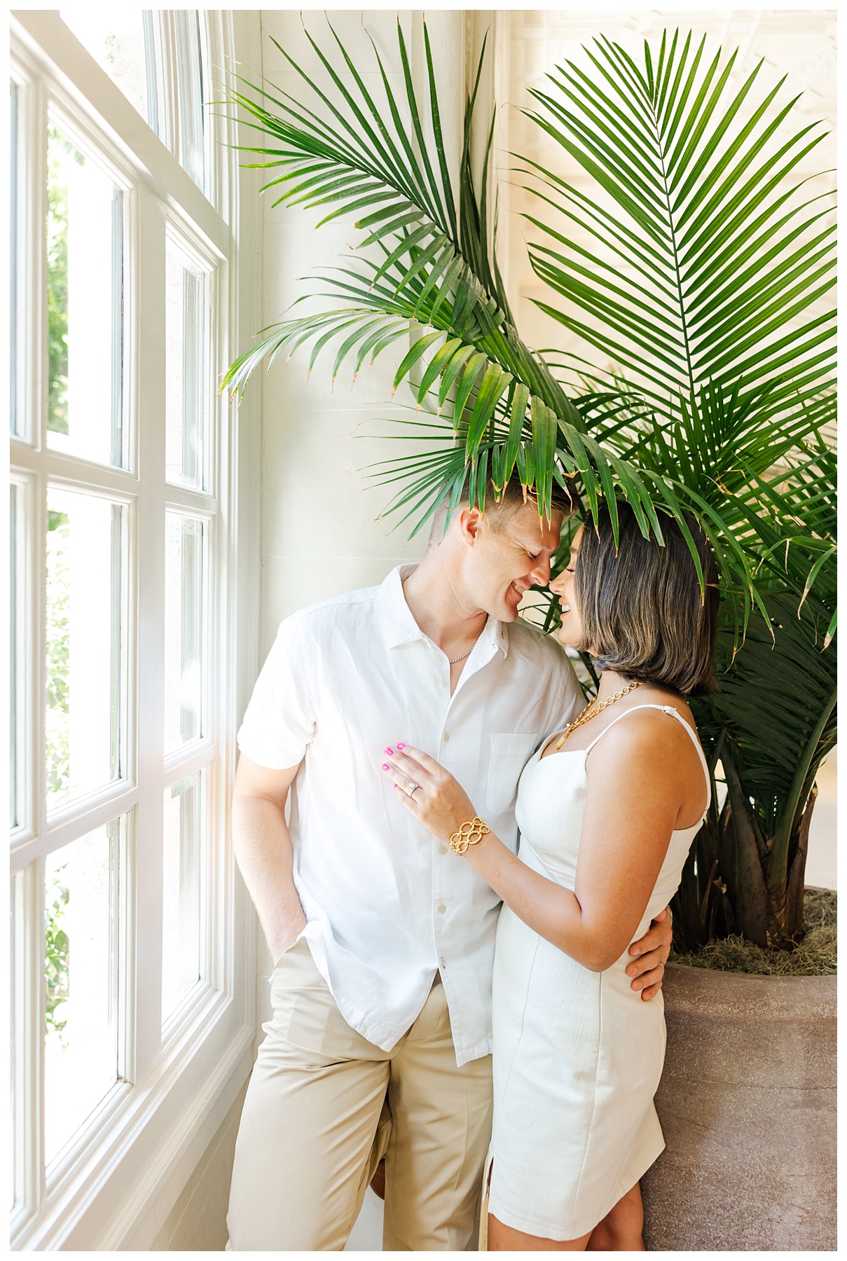 A couple poses for their engagement photos at The Boca Raton resort 