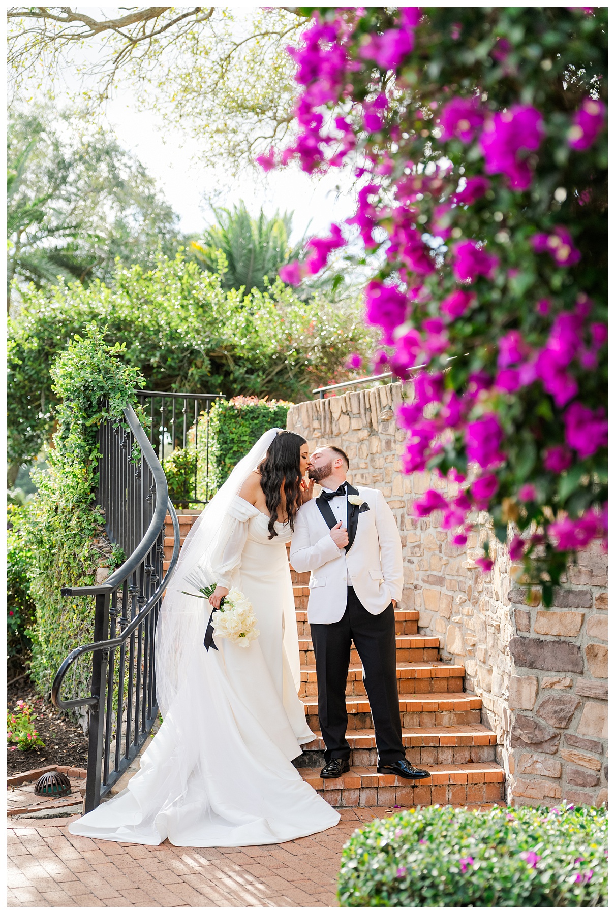 Bride and groom stand on the staircase at The Parkland Golf & Country Club