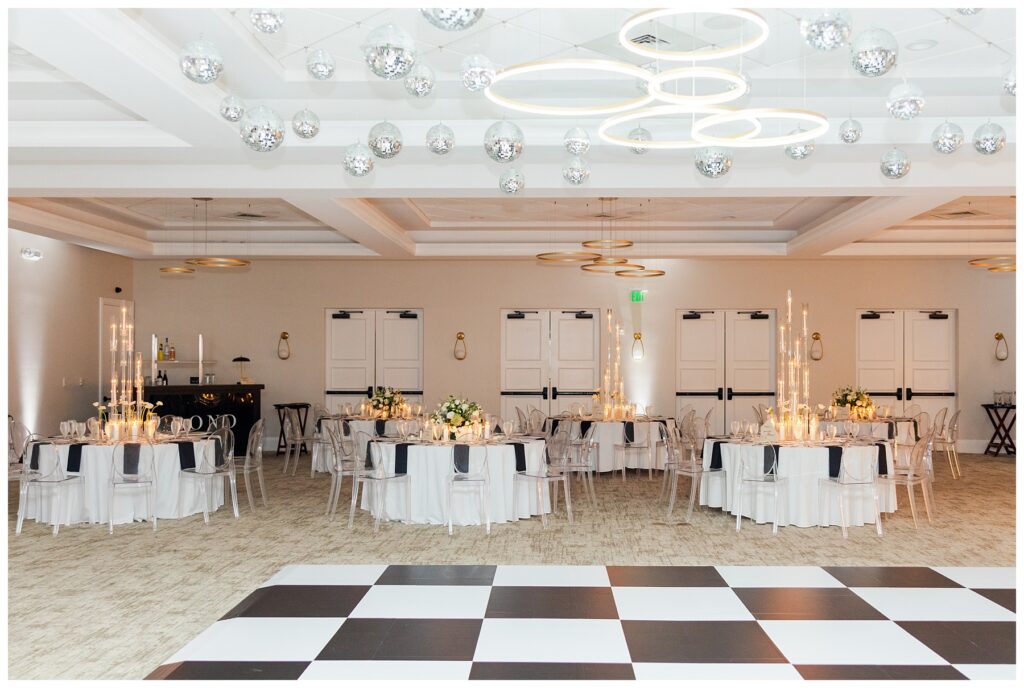 Reception details Bride and groom stand on the staircase at The Parkland Golf & Country Club included disco balls and white florals