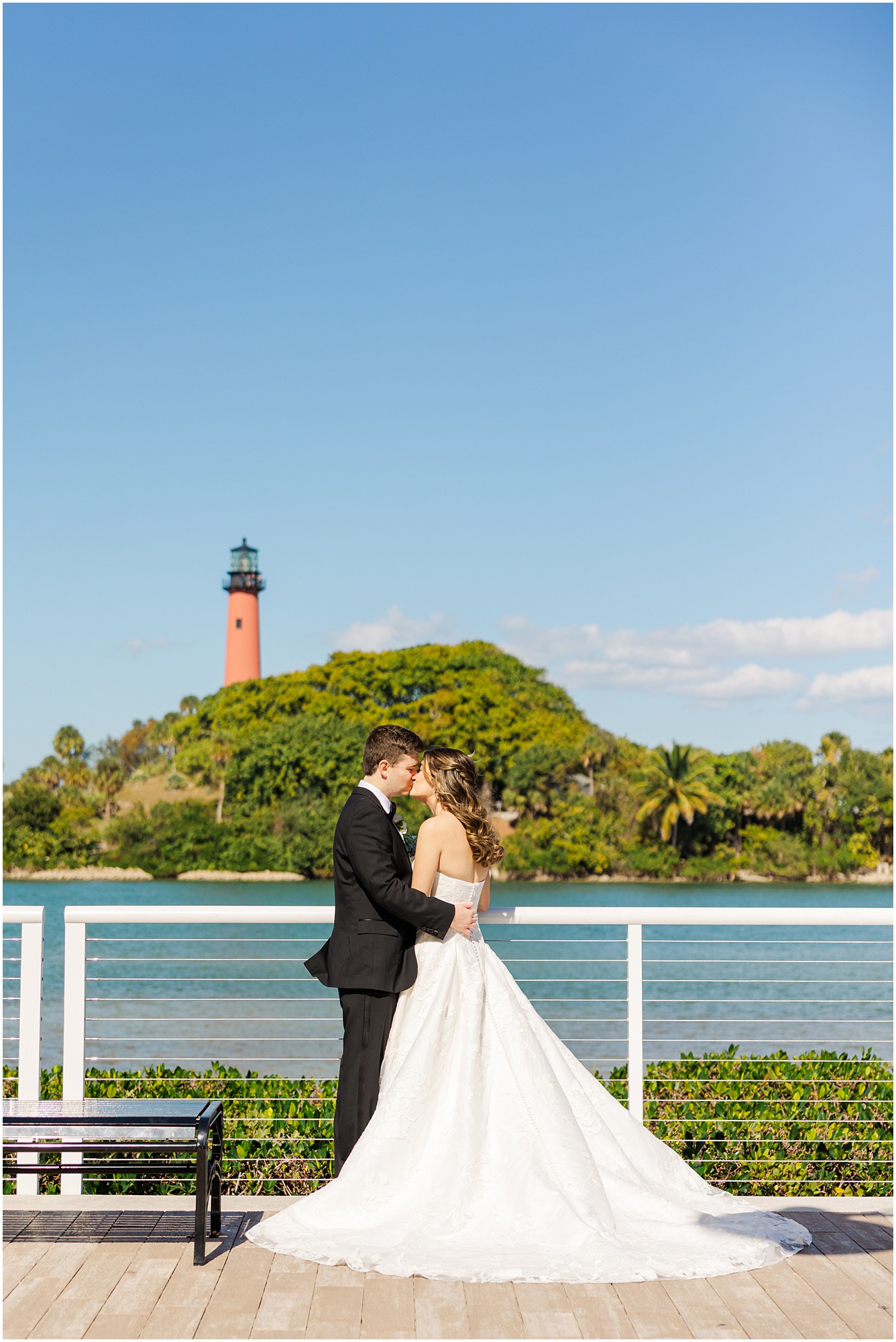 Bride and groom share a kiss at their Pelican Club wedding 
