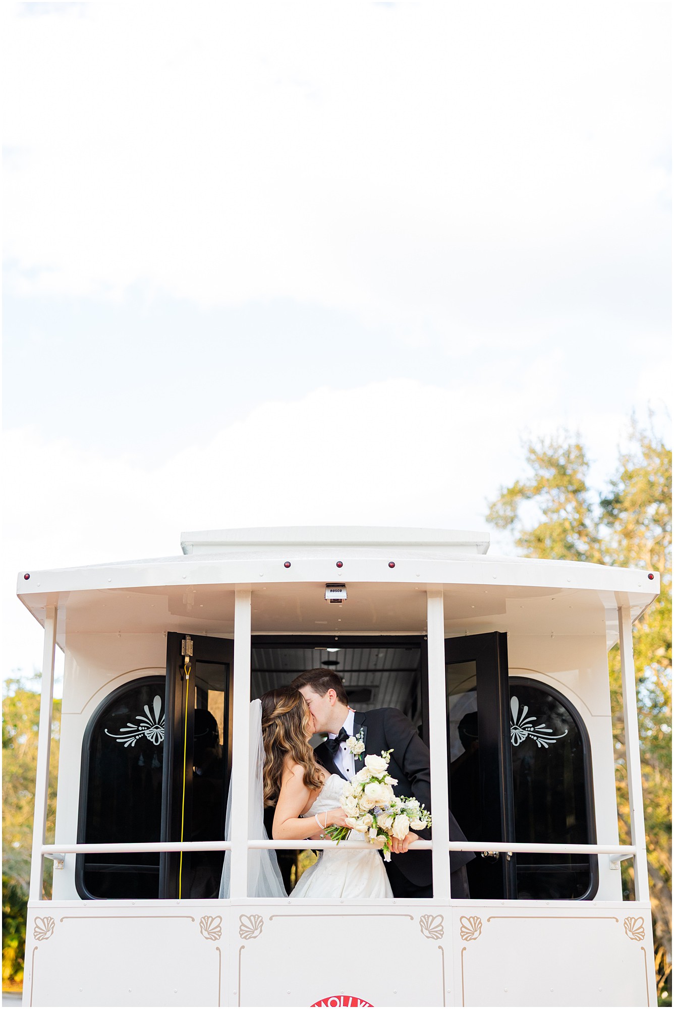 bride and groom share a kiss on Molly's Trolly in Jupiter Florida