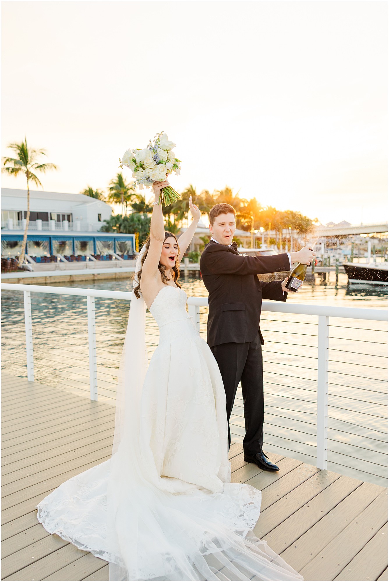 bride and groom pop champagne at their Pelican Club Wedding