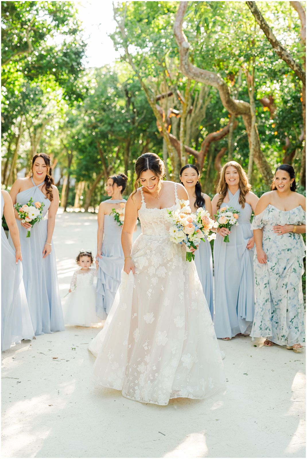 Key Largo Wedding Photographer captures bride walking with her bridesmaids at Baker's Cay in Key Largo